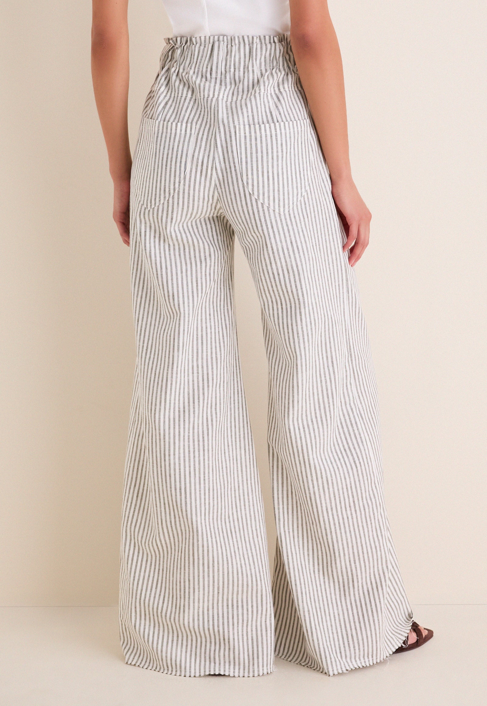 Juniper Stripe Linen Tulip Wide Leg Pant showcasing classic, effortless style with a relaxed, high-end silhouette; features a cinched waist and flared legs for fun, warm-weather wear.