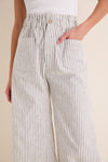 The Juniper Stripe Linen Tulip Wide Leg Pant offers a classic, effortless style with a fun, high-end vibe. Featuring a wide-leg design and front patch pockets.