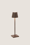 Rust Poldina Pro Table Micro Lamp: a classic, effortless cordless lamp with touch control, perfect for indoor/outdoor use. High-end design for fun, versatile lighting.