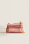 Rose Water Malaya Clutch: A classic, high-end piece with an effortless, fun vibe, featuring a marbled resin design, gold details, and a removable chain strap.