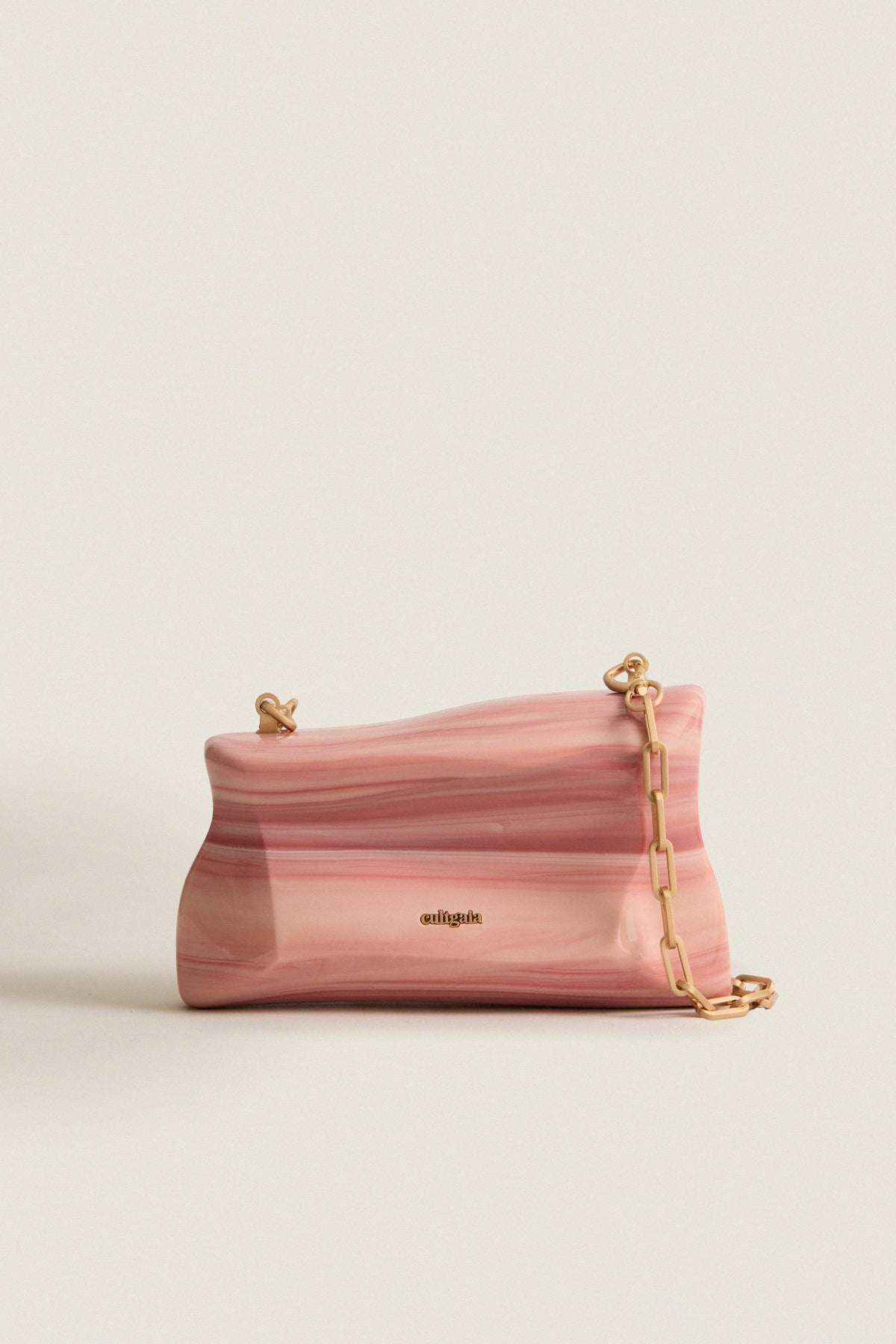 Rose Water Malaya Clutch: A classic, high-end piece with an effortless, fun vibe, featuring a marbled resin design, gold details, and a removable chain strap.