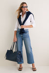 Woman wearing classic Black RB4473D Sunglasses, a white shirt, jeans, and a navy sweater. Her look is effortless and high-end, perfect for fun, casual outings.