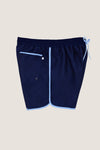 Navy Boardie swim trunks with light-blue trim, featuring an elastic drawstring waist, side pockets, and a back patch pocket, offer a classic, effortless, and fun high-end style.