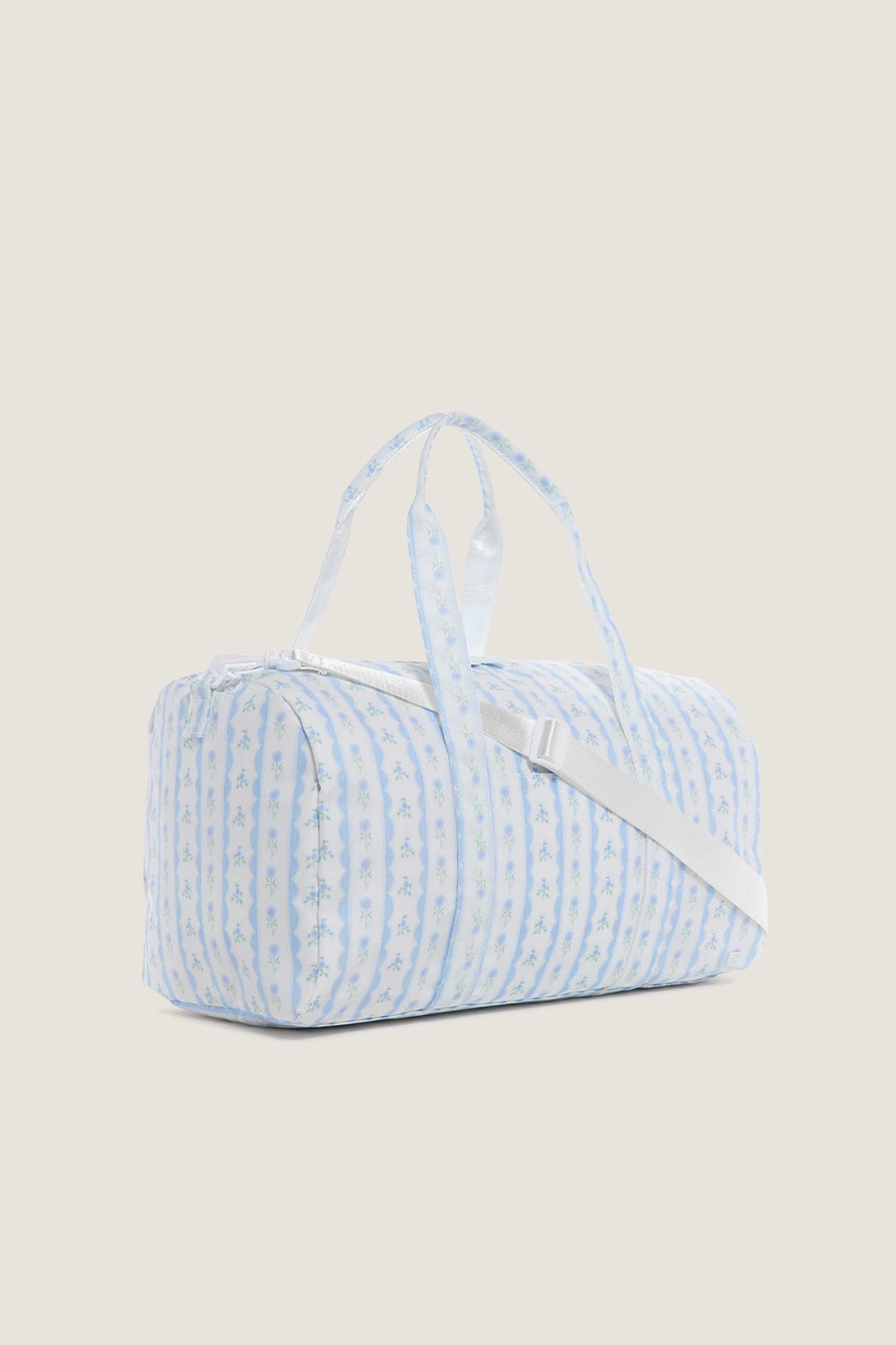 Floral Blue Ribbon Weekender Duffel Bag: A classic, high-end travel essential with an effortless, fun floral-stripe design, two handles, and a detachable shoulder strap for versatile carrying.