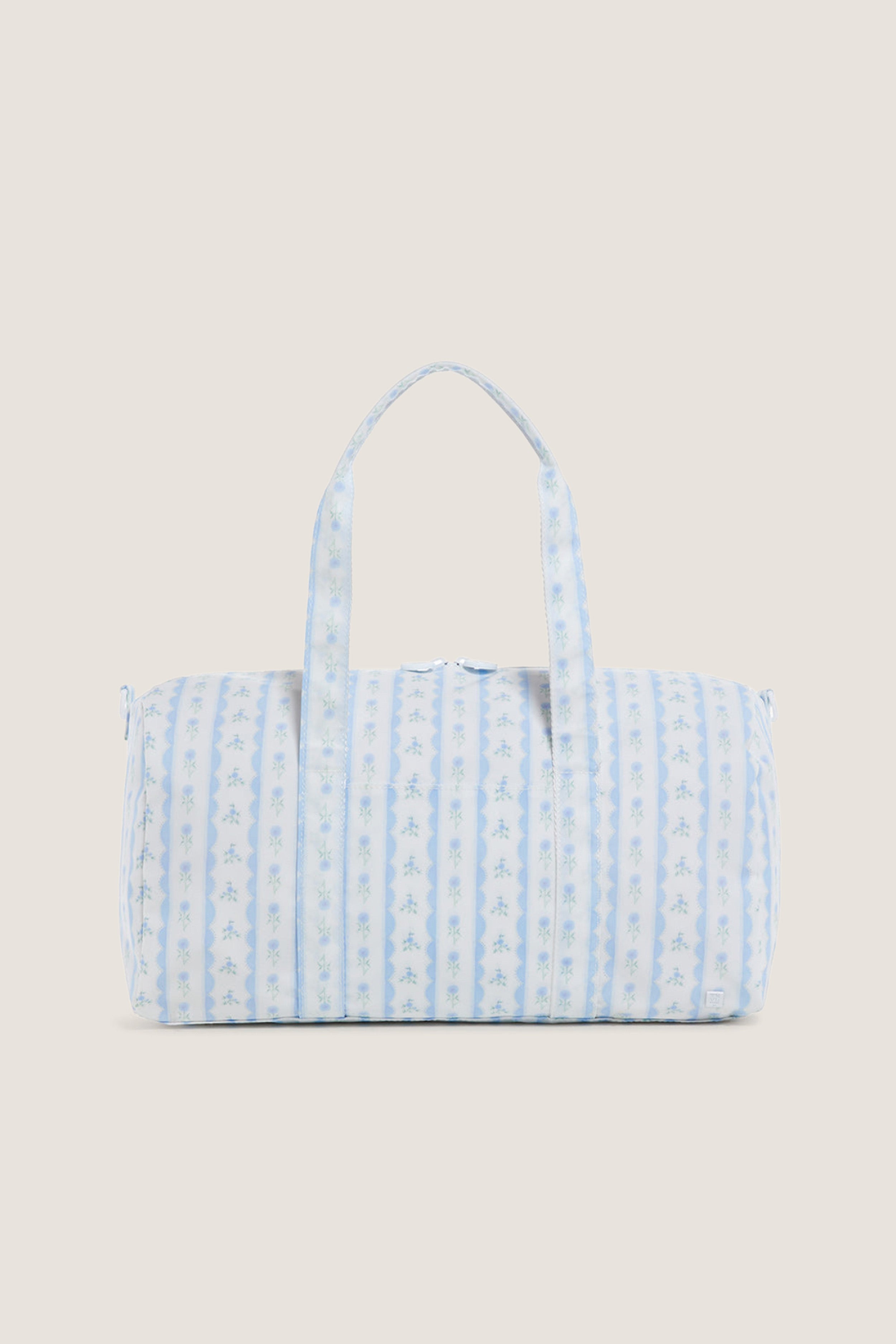 Floral Blue Ribbon Weekender Duffel Bag with classic blue and white stripes, tiny floral motifs, and effortless two-way zipper, exudes fun and high-end practicality.