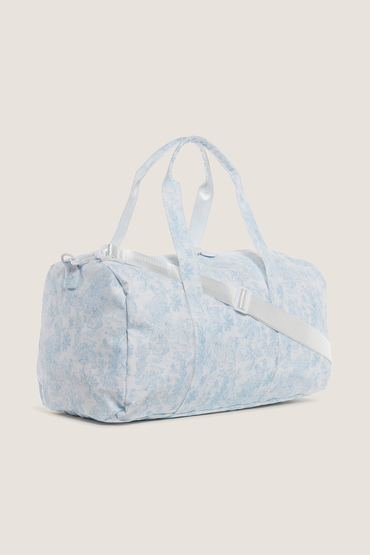 Classic Blue Bunny Toile Weekender Duffel Bag with detachable strap, white zipper closure, and interior mesh pocket. Effortless, fun design perfect for high-end, practical travel.