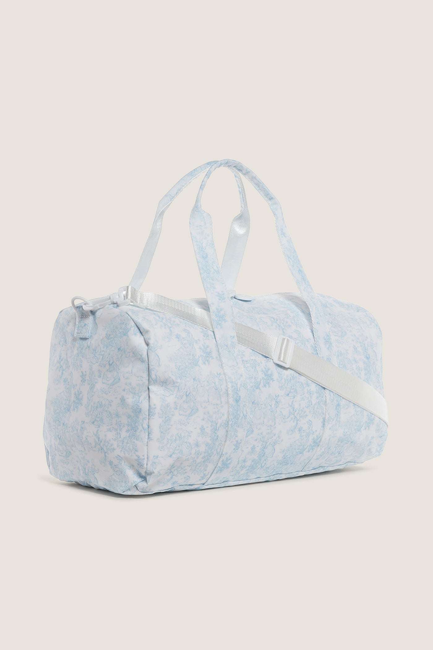 Classic Blue Bunny Toile Weekender Duffel Bag with detachable strap, white zipper closure, and interior mesh pocket. Effortless, fun design perfect for high-end, practical travel.