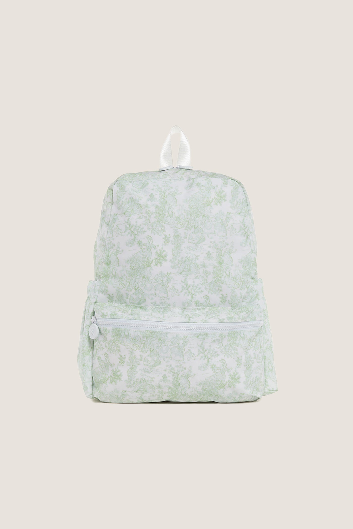 Green Bunny Toile Backpack with a classic toile-style pattern, featuring an effortless, fun design with a small zippered front pocket and white accents, perfect for high-end everyday use.