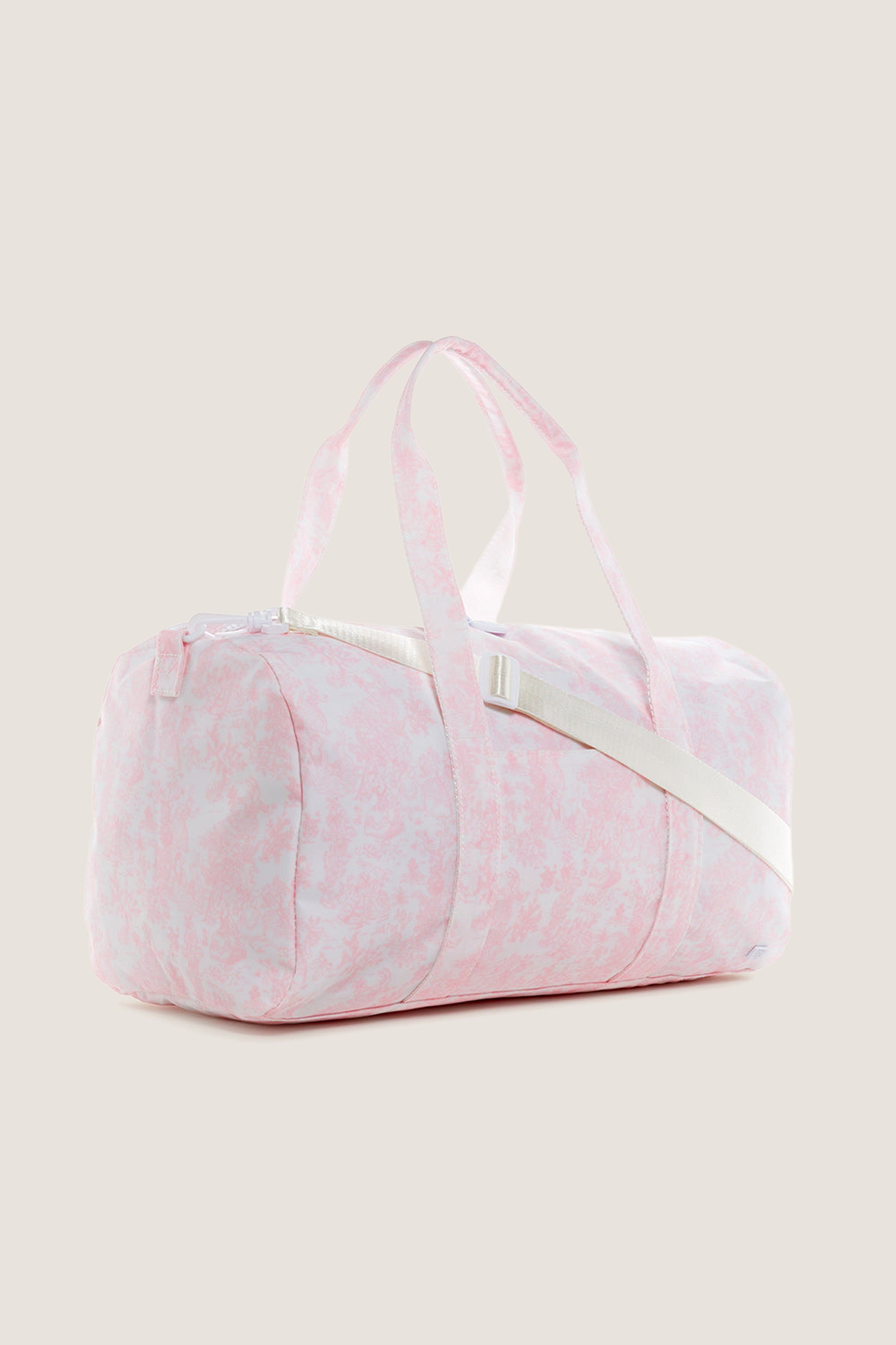 Classic Pink Bunny Toile Weekender Duffel Bag with an effortless, fun marbled design. Features include a detachable shoulder strap, two-way zipper, and interior mesh pocket for high-end practicality.