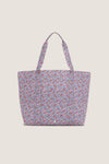 Garden Floral Jumbo Tote with a ditsy floral pattern, featuring an exterior pocket and sturdy handles, embodies effortless, classic style perfect for a fun, high-end shopping experience.