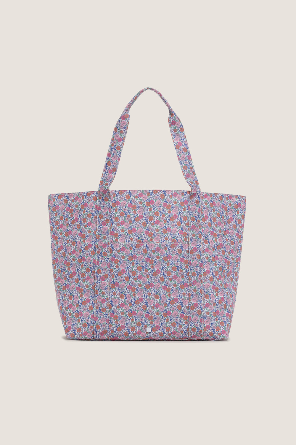 Garden Floral Jumbo Tote with a ditsy floral pattern, featuring an exterior pocket and sturdy handles, embodies effortless, classic style perfect for a fun, high-end shopping experience.