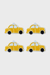 Four yellow cartoon-style taxi car illustrations, inspired by NYC coaster designs from Chefanie, are arranged in a two-by-two grid on a plain white background.