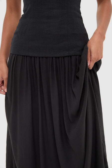 Effortlessly classic, the Black Lenise Maxi Dress features a fitted bodice and draped skirt, embodying high-end style with fun, versatile elegance.