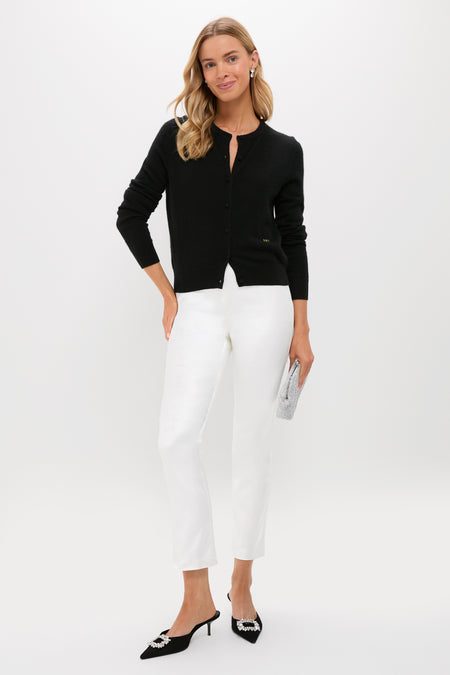 Woman models classic Winter White Velvet Ashford Pants, paired with an effortless black cardigan and high-end accessories, including kitten-heel mules and a rhinestone clutch.