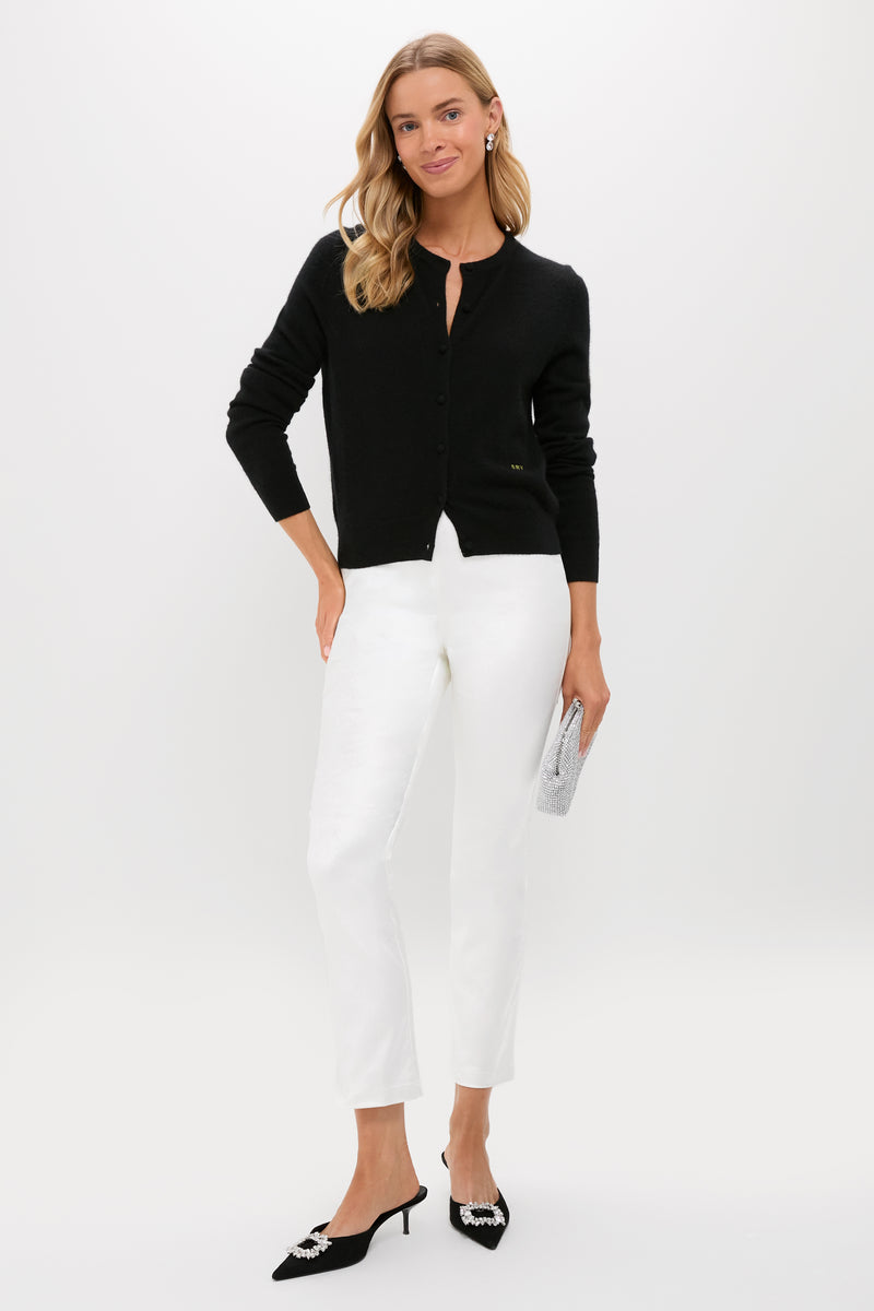 Woman models classic Winter White Velvet Ashford Pants, paired with an effortless black cardigan and high-end accessories, including kitten-heel mules and a rhinestone clutch.