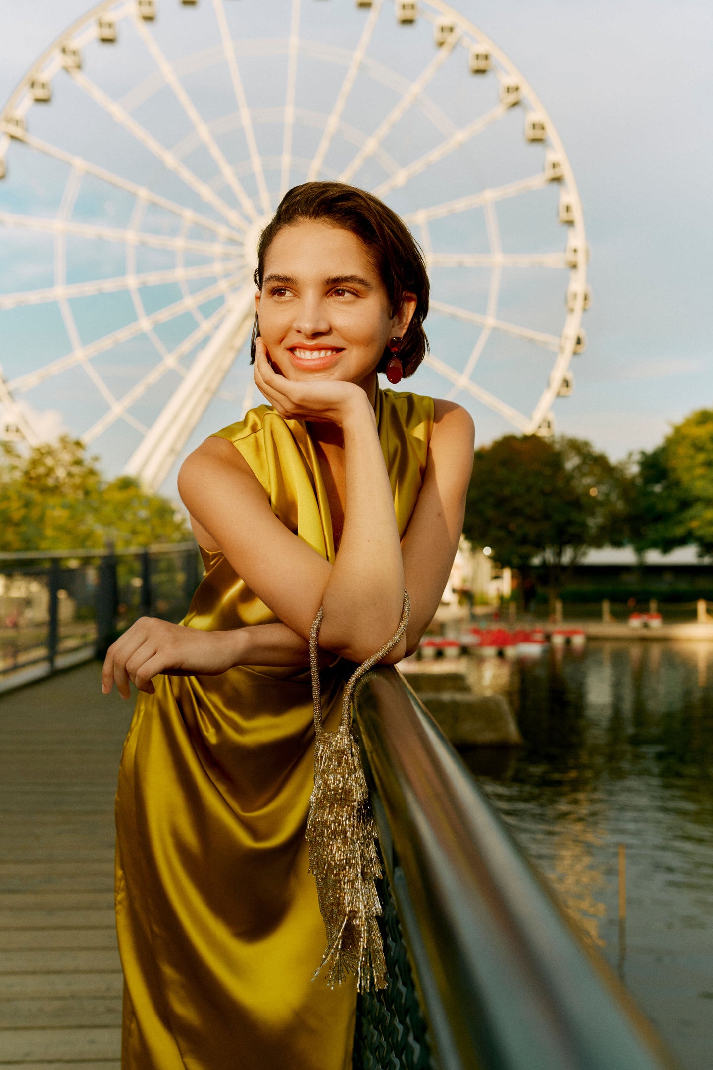 A woman effortlessly exudes high-end style wearing Carnelian Xiomara Earrings. Perfect for any occasion, these classic drop earrings add a fun, sophisticated touch.
