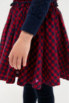 Child wearing the classic Red Blue Check Gianna Skirt with ruffled trim and elastic waist, embodying effortless, high-end style that's fun and perfect for any occasion.