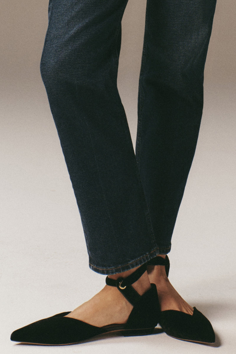 Classic Black Corinna Bow Flats in croc-embossed velvet, featuring a pointed toe and elegant bow ankle strap. Effortless, high-end style for fun, confident outings.