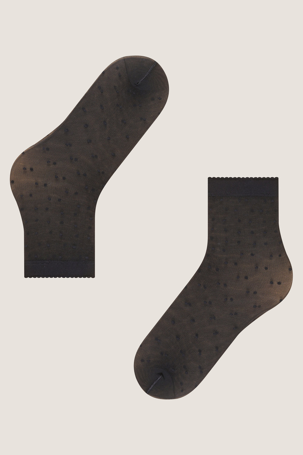 Black Sheer Polka Dot Socks with scalloped cuffs and tiny dot pattern, offering an effortless, fun, and high-end look for any outfit.