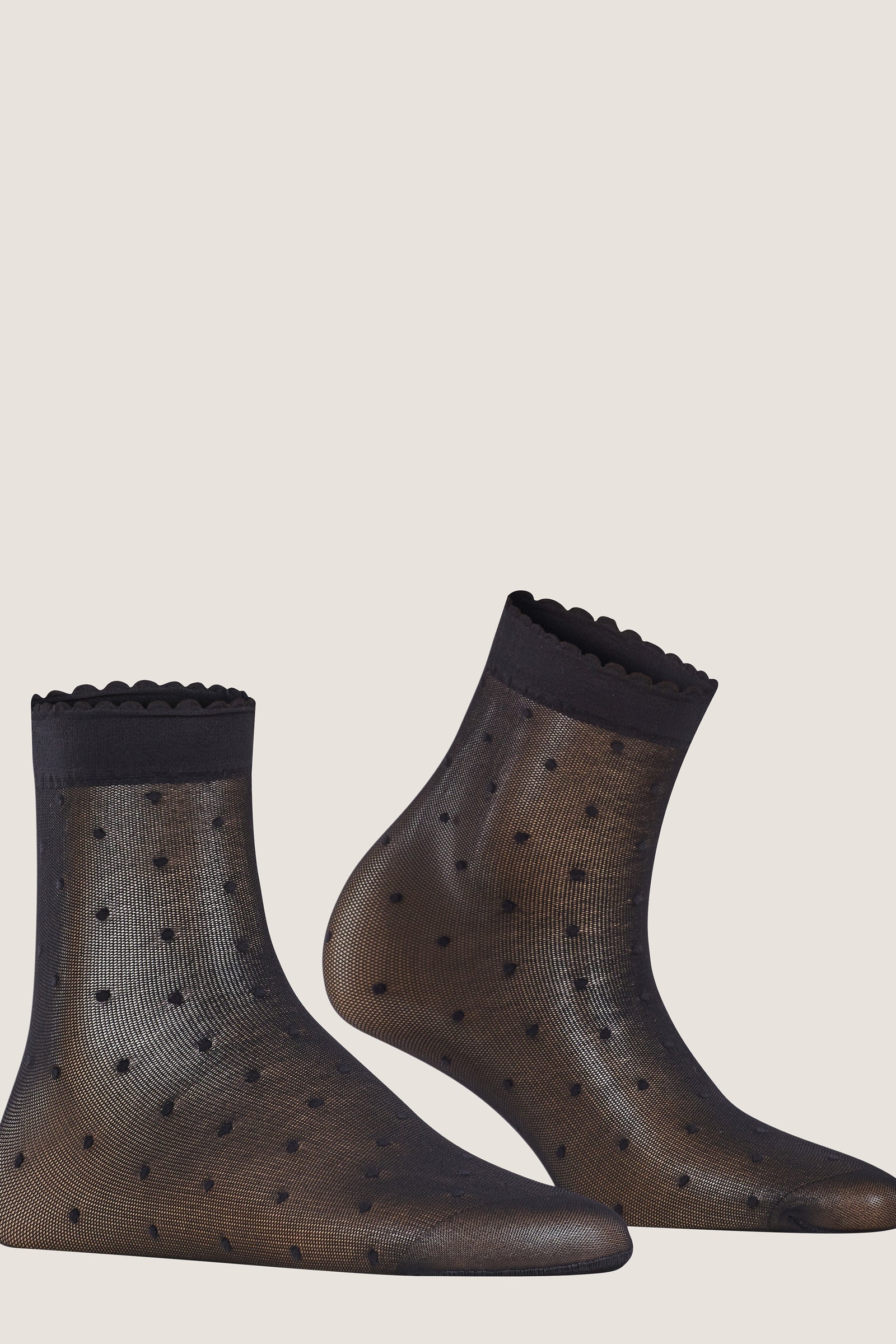Black Sheer Polka Dot Socks with scalloped cuffs, combining classic style with an effortless, fun twist for a high-end, versatile look.
