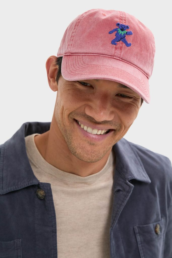 Young man wearing the Nantucket Red Dancing Bear Needlepoint Hat, featuring classic and fun hand-stitched design on cotton twill, embodying an effortless, high-end style.