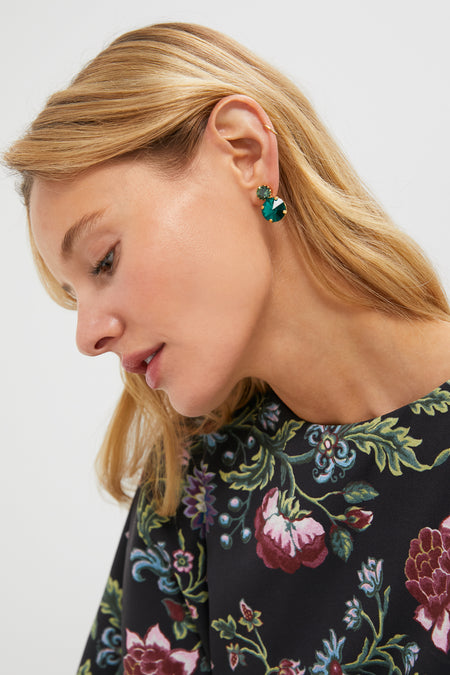 Close-up of a woman wearing the classic Emerald Myrla Earrings, featuring two green stones in a high-end, effortless design, perfect for fun, elevated style.