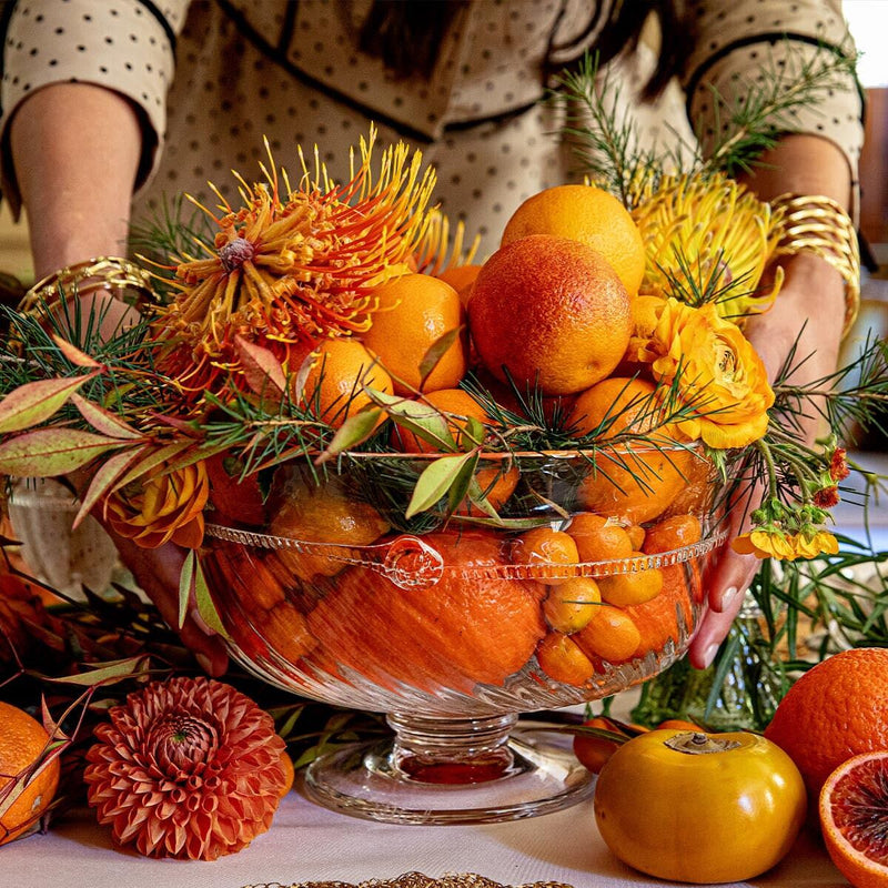 Graham 10 Footed Bowl elegantly holds citrus and blooms, showcasing effortless, high-end style—a classic, fun centerpiece for any table setting.