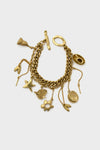 Alemais gold charm bracelet with a chunky chain and dangling charms—star, heart, flower, coin, and more. This vintage-inspired piece brings playful elegance to any outfit.
