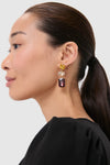 Woman wearing Wine Allie Earrings featuring classic, colorful, faceted stones in an effortless drop design, ideal for fun and high-end occasions with sleek styling.