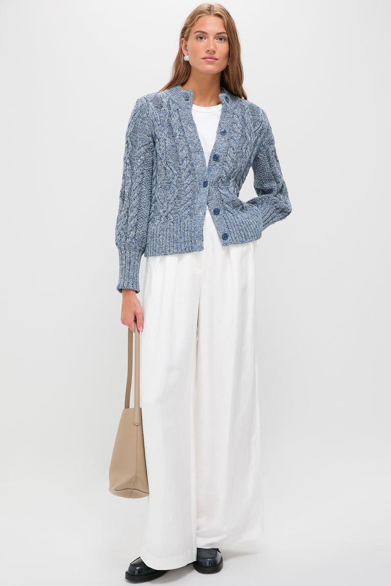 Model wearing Black Dylan Loafers with a classic penny loafer design and chunky sole, styled effortlessly with chic wide-leg trousers and a simple leather tote.