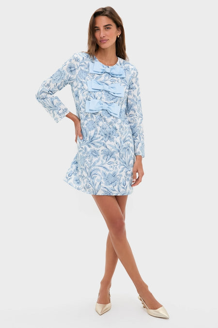Model in Blue Chintz Clarice Bows Dress, featuring a classic A-line silhouette with playful floral print and bows, exuding effortless, high-end elegance and fun.