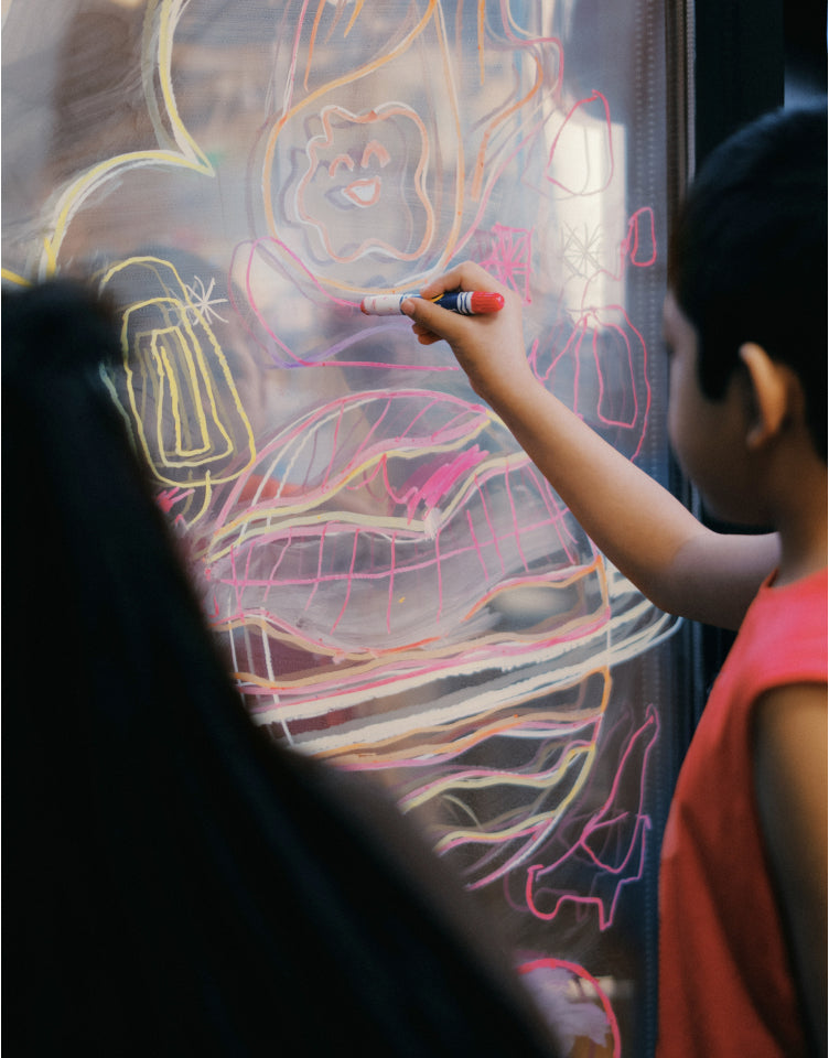 Child drawing on a wall. 