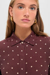Young woman wearing the Night Print Crepe Shirt, a classic high-end top with a playful polka-dot design and chunky gold hoop earrings, exuding an effortless, fun sophistication.