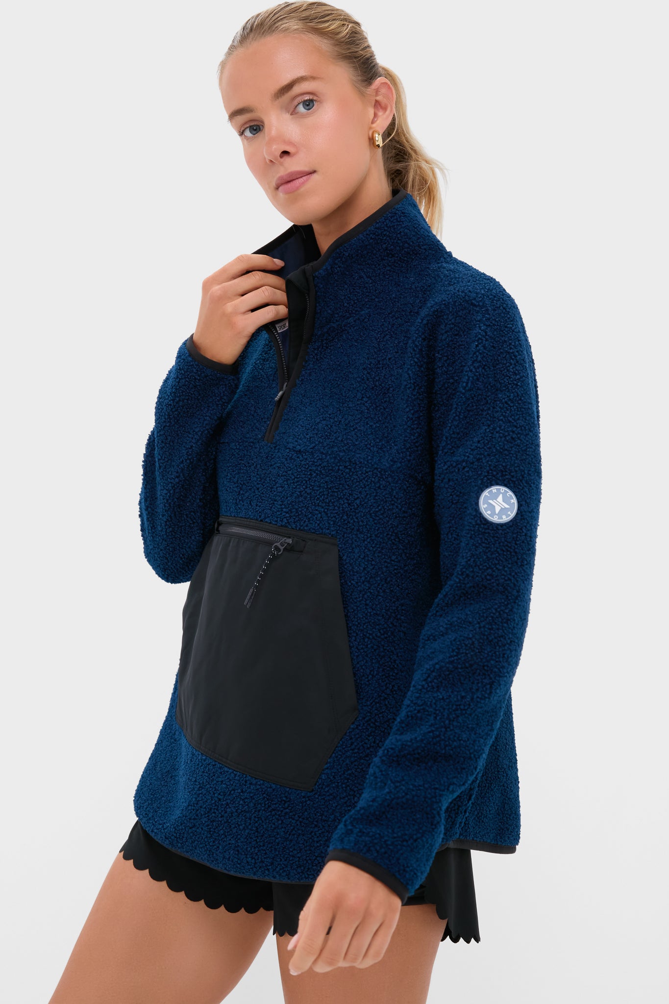 Model wearing a classic Navy Fleece Cady Quarter Zip, featuring a sherpa-style design with a quarter-zip collar and black zip-pocket, embodying effortless, high-end style.