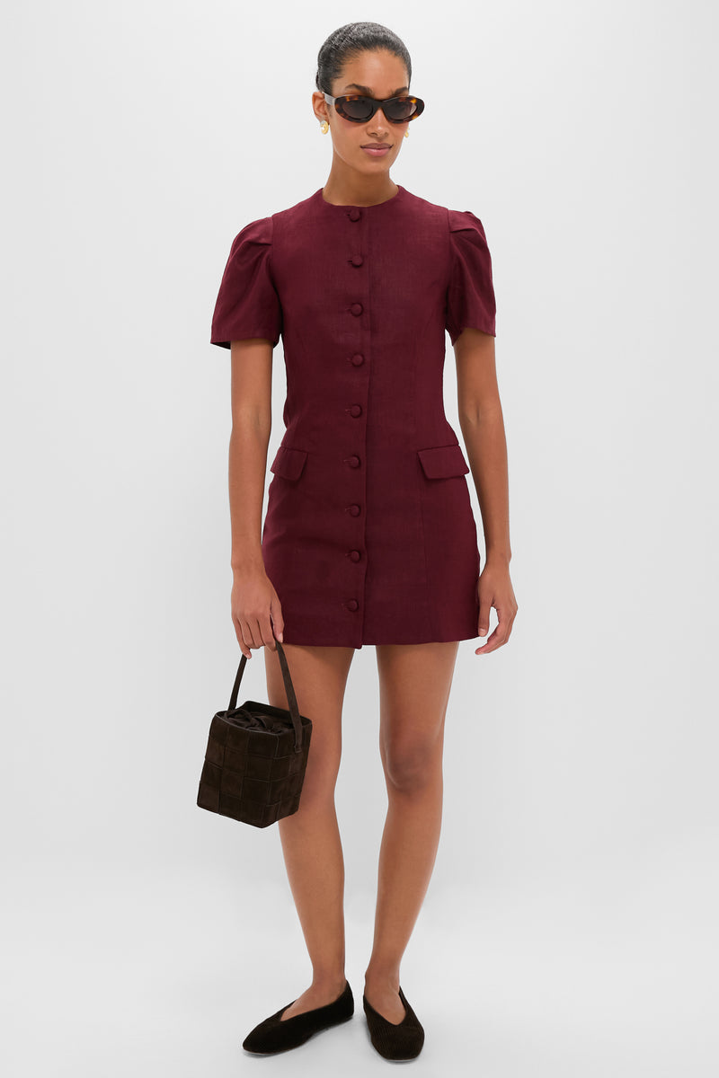 A woman models classic Gold Michelle Earrings, exuding effortless elegance with engraved lines, paired with a chic burgundy dress and fun accessories for a high-end look.