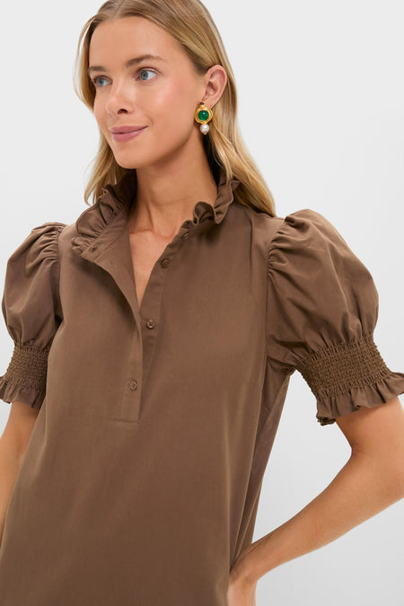 Blonde woman in a brown blouse with ruffled collar and puff sleeves, showcasing a classic, effortless style perfect for pairing with the Mocha Embroidery Eliza Midi Dress.