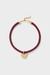 Maroon Lelani Necklace: A classic, high-end braided cord choker with an effortless gold heart charm and adjustable clasp, offering fun, versatile styling options.
