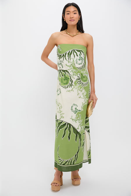 Woman in the Ireland Green Wess Midi Dress, showcasing a classic, effortless look with a strapless design, sleek side slit, and high-end botanical pattern.