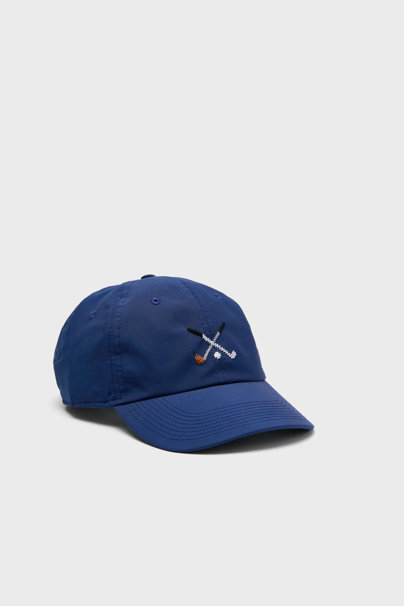 A blue Smathers and Branson needlepoint hat with embroidered crossed golf clubs and ball on the front—perfect for any golf lover.