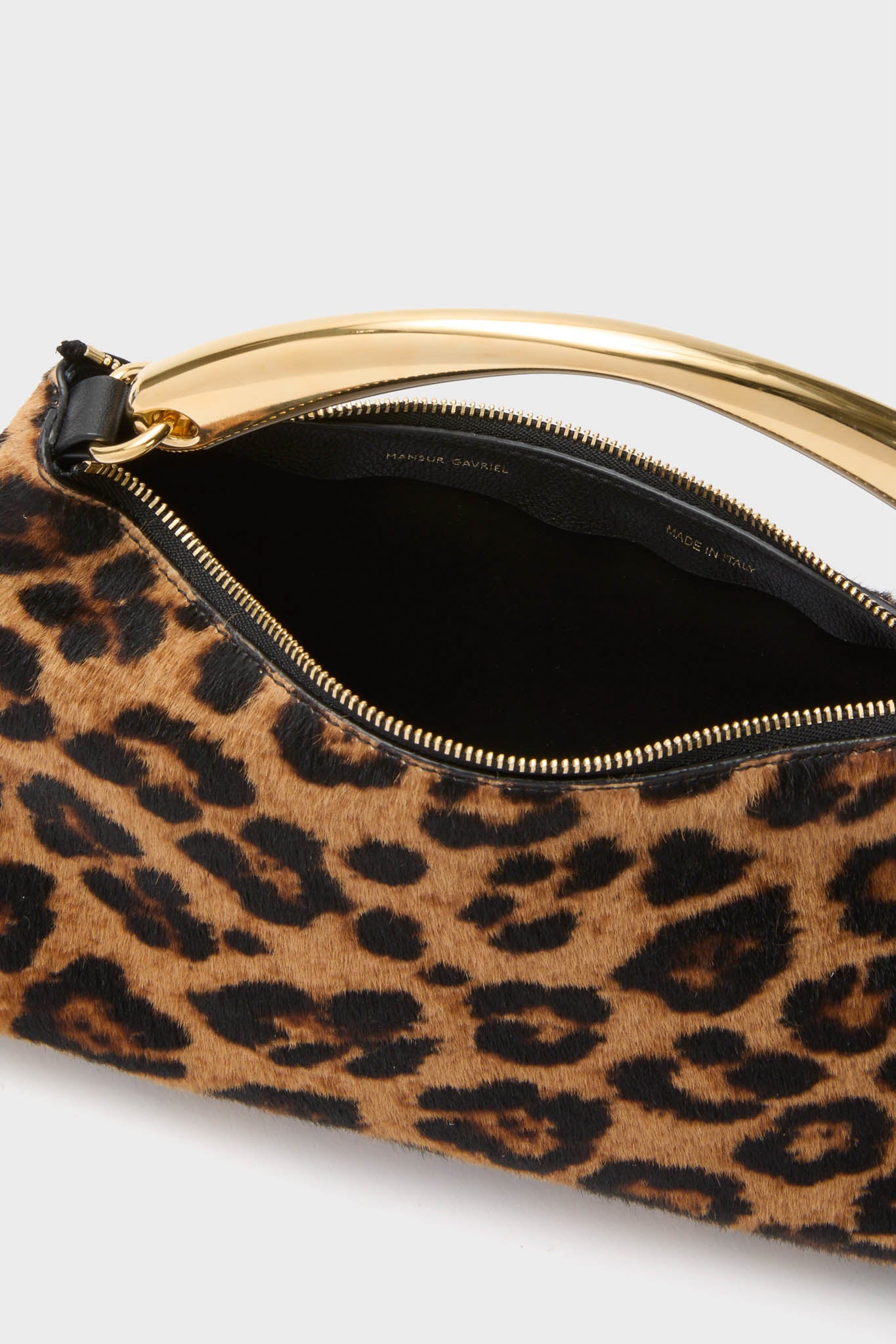 Leopard Metal Handle Rhea Bag: A classic, effortless designer handbag with a leopard-spot finish, polished gold-tone handle, and sleek zip closure. High-end Italian craftsmanship for fun, stylish outings.