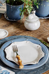 Classic Chambray Berry & Thread Dinner Plate on a rustic table, paired effortlessly with a bamboo-handled fork, embodies high-end, fun farmhouse elegance in a casually sophisticated setting.