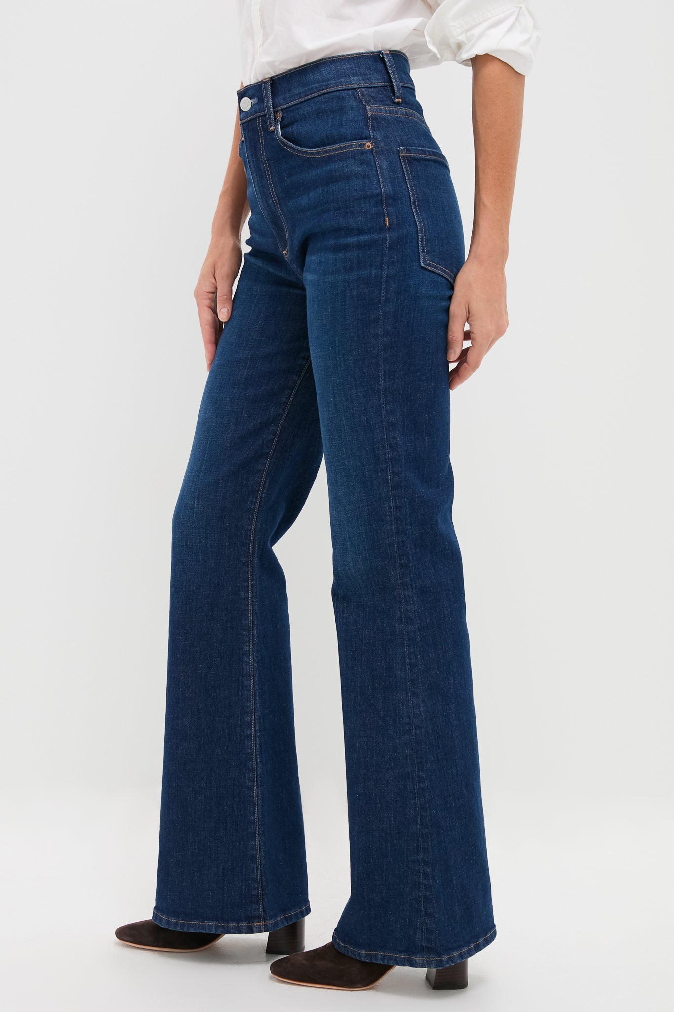Zoe Gigi High Rise Skinny Flare jeans, classic dark-indigo with flared hem, high-end five-pocket design, effortlessly paired with white top and block-heeled boots for a fun look.