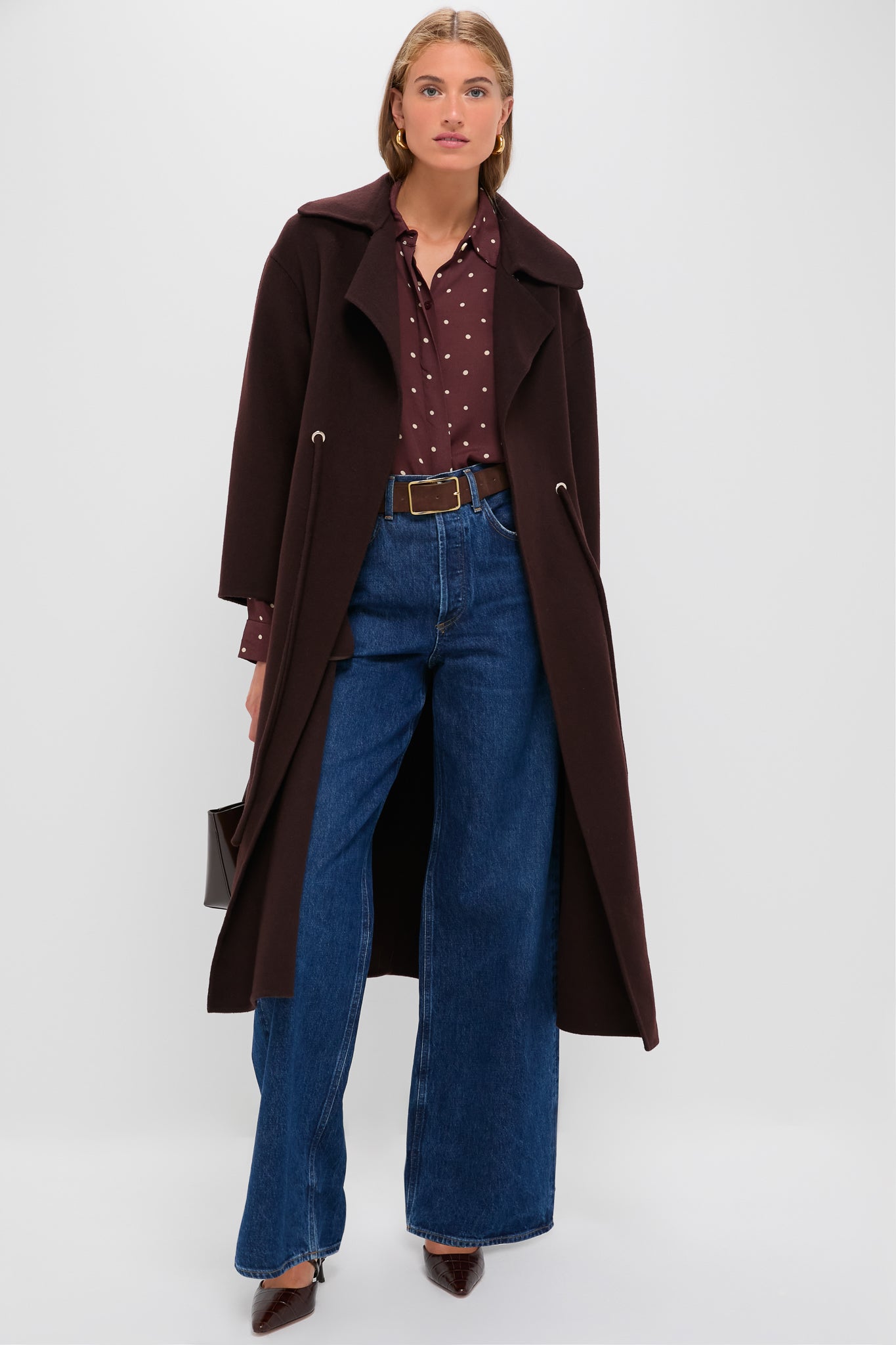 Woman wearing the classic, high-end Chocolate Kate Coat, featuring a wide V-collar and drawstring waist, effortlessly styled with jeans and a burgundy blouse.