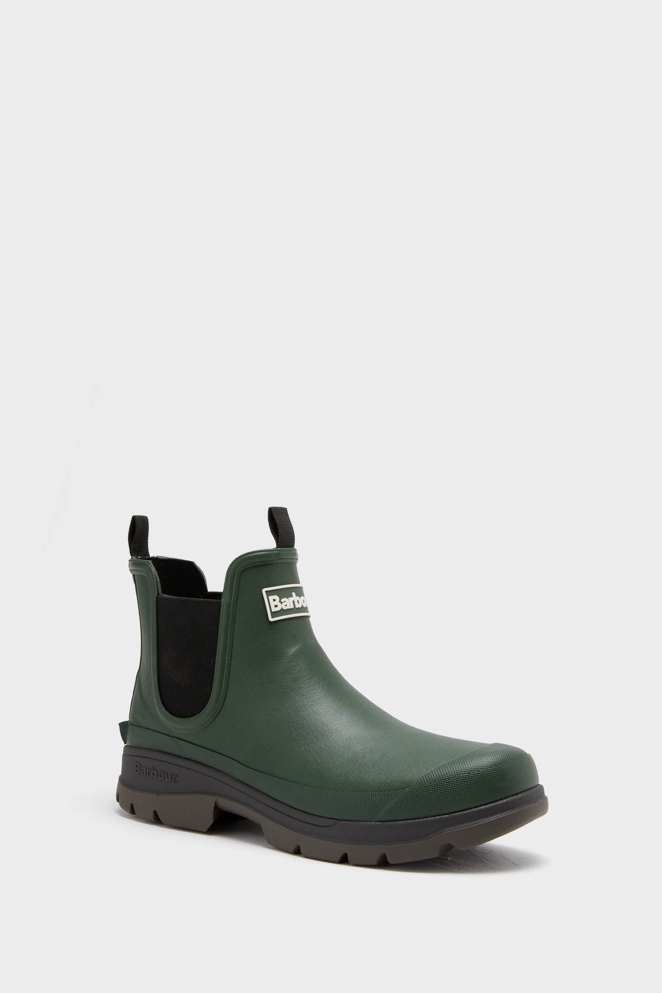The Barbour Nimbus boot is a green men's Chelsea-style welly with black elastic side panels, a front Barbour logo, and a pull tab for easy wear.