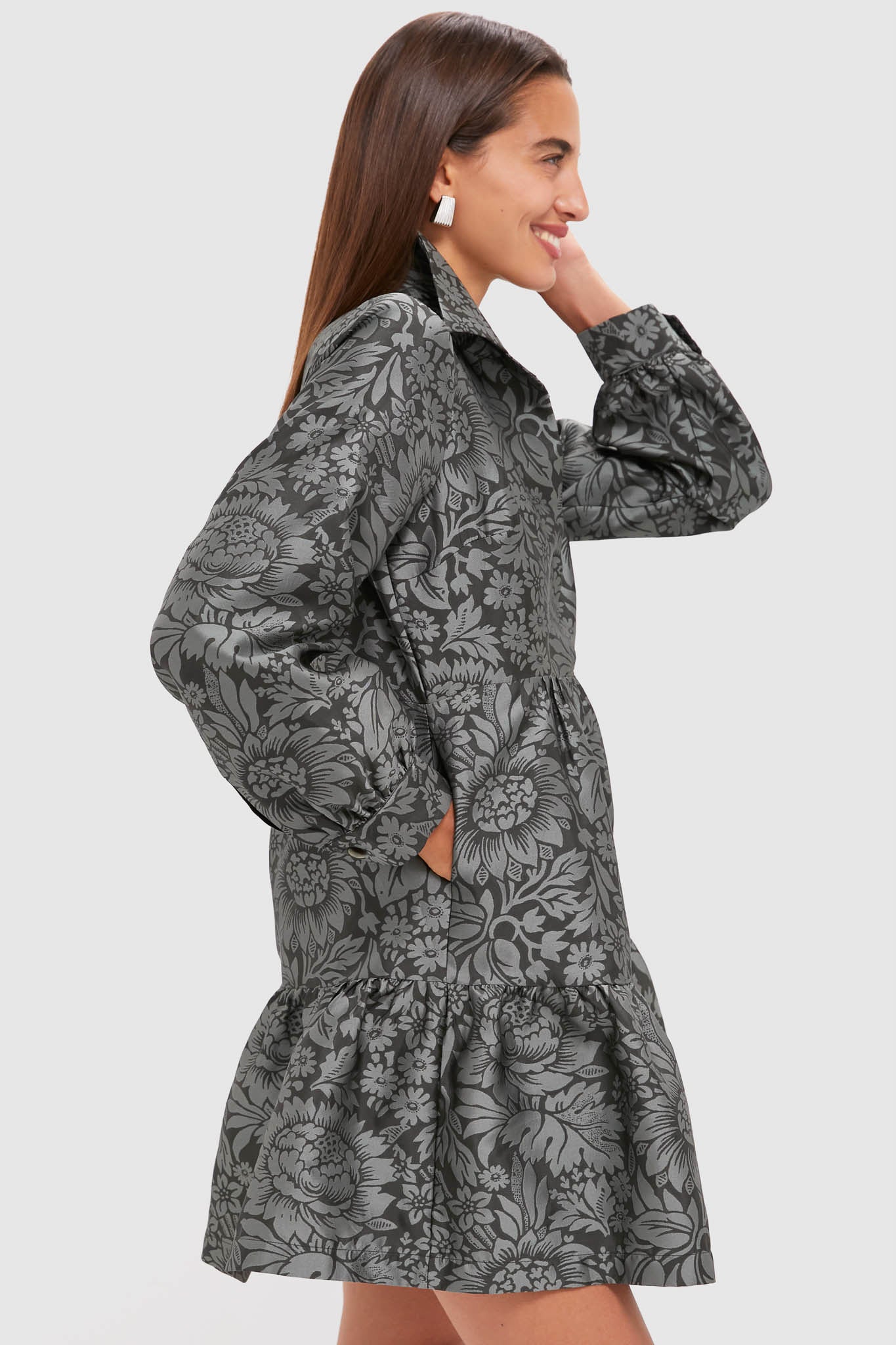 Woman in profile wearing the classic Emerald Mirasol Jacquard Alette Dress, showcasing its effortless elegance with a floral jacquard pattern, puff sleeves, and flared hem.