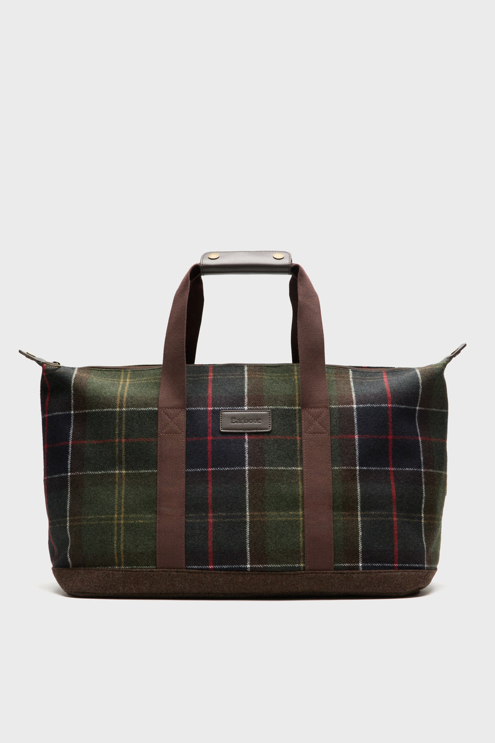A Barbour rectangular tartan duffel bag with two brown handles, a leather front patch, and a zippered top. Features green, red, and yellow stripes.