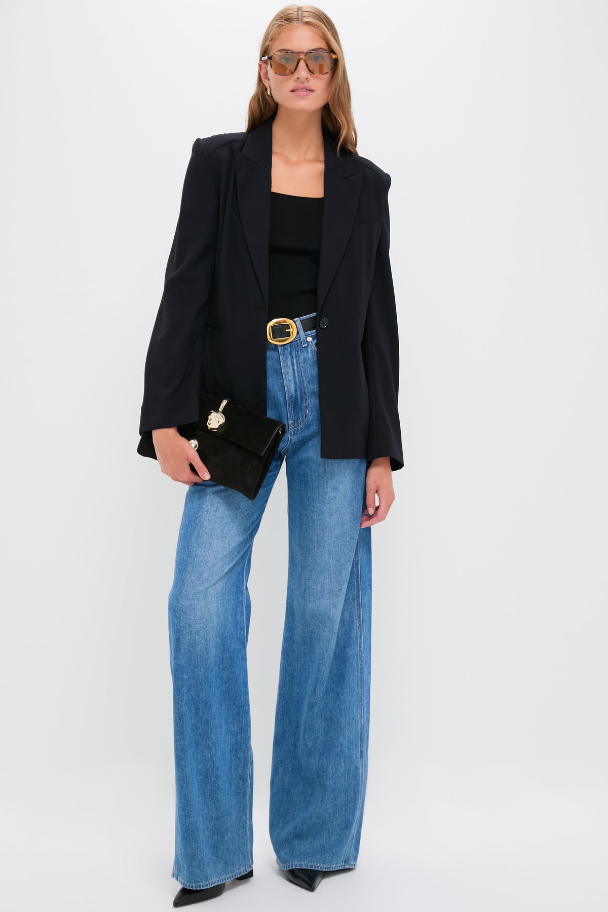 Model in the classic Midnight Boy Blazer, showcasing effortless style with tailored wool crepe, paired with high-waisted jeans, embodying high-end, fun sophistication.
