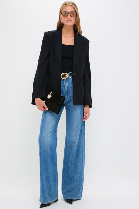 Model in the classic Midnight Boy Blazer, showcasing effortless style with tailored wool crepe, paired with high-waisted jeans, embodying high-end, fun sophistication.