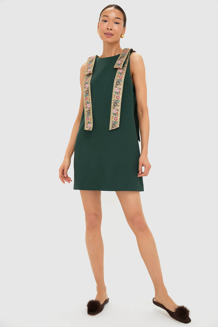 Model wears the classic Garden Scrollwork Jacquard Bow Rosie Dress, an effortless shift with embroidered straps, styled with high-end brown mule flats for a fun, chic look.