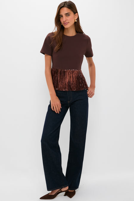 Woman models the Bronze Metallic Fringe Francie Short Sleeve Blouse, effortlessly combining classic and fun style with high-end, chic details, paired with dark indigo jeans.